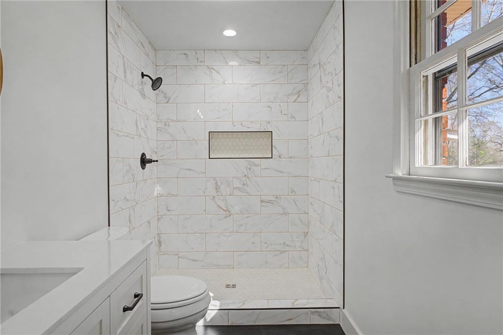 115 Devonwood Drive Calhoun, GA 30701 - Photo 19 of 35 a bathroom with a shower a toilet and a sink