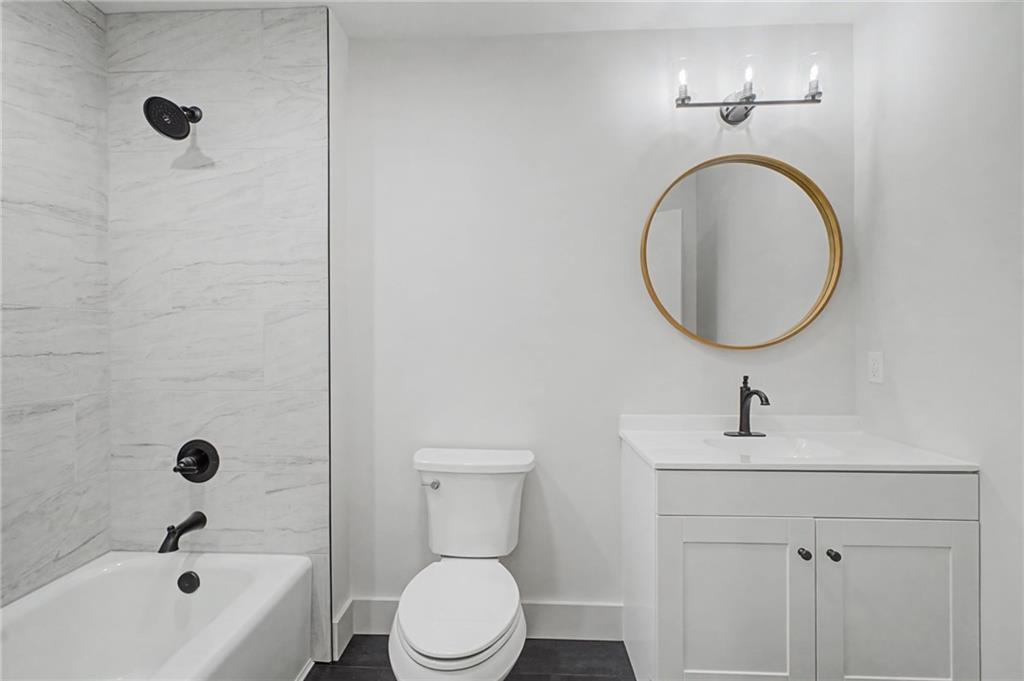 115 Devonwood Drive Calhoun, GA 30701 - Photo 22 of 35 a bathroom with a sink a toilet and shower