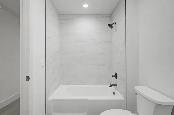 a bathroom with a bathtub and a toilet