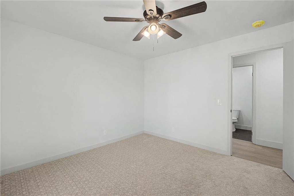 115 Devonwood Drive Calhoun, GA 30701 - Photo 25 of 35 an empty room with a ceiling fan and a window