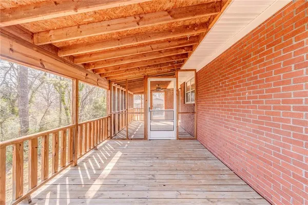 a view of a porch with wooden floor and iron stairs