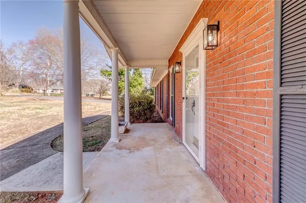 a view of a house with backyard and mountain view from a corridor