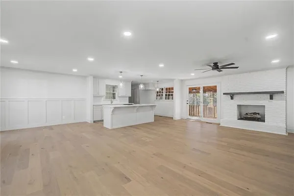 a view of a kitchen with a sink and a fireplace