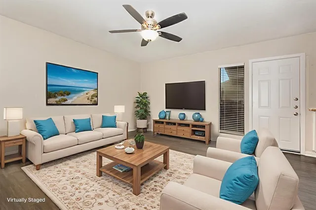 a living room with furniture and a flat screen tv