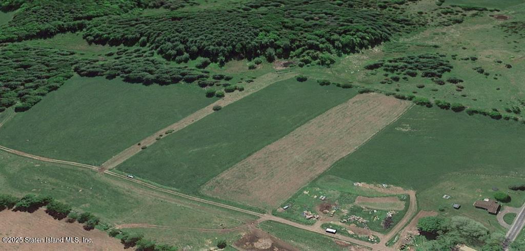 a view of a green yard with a lake