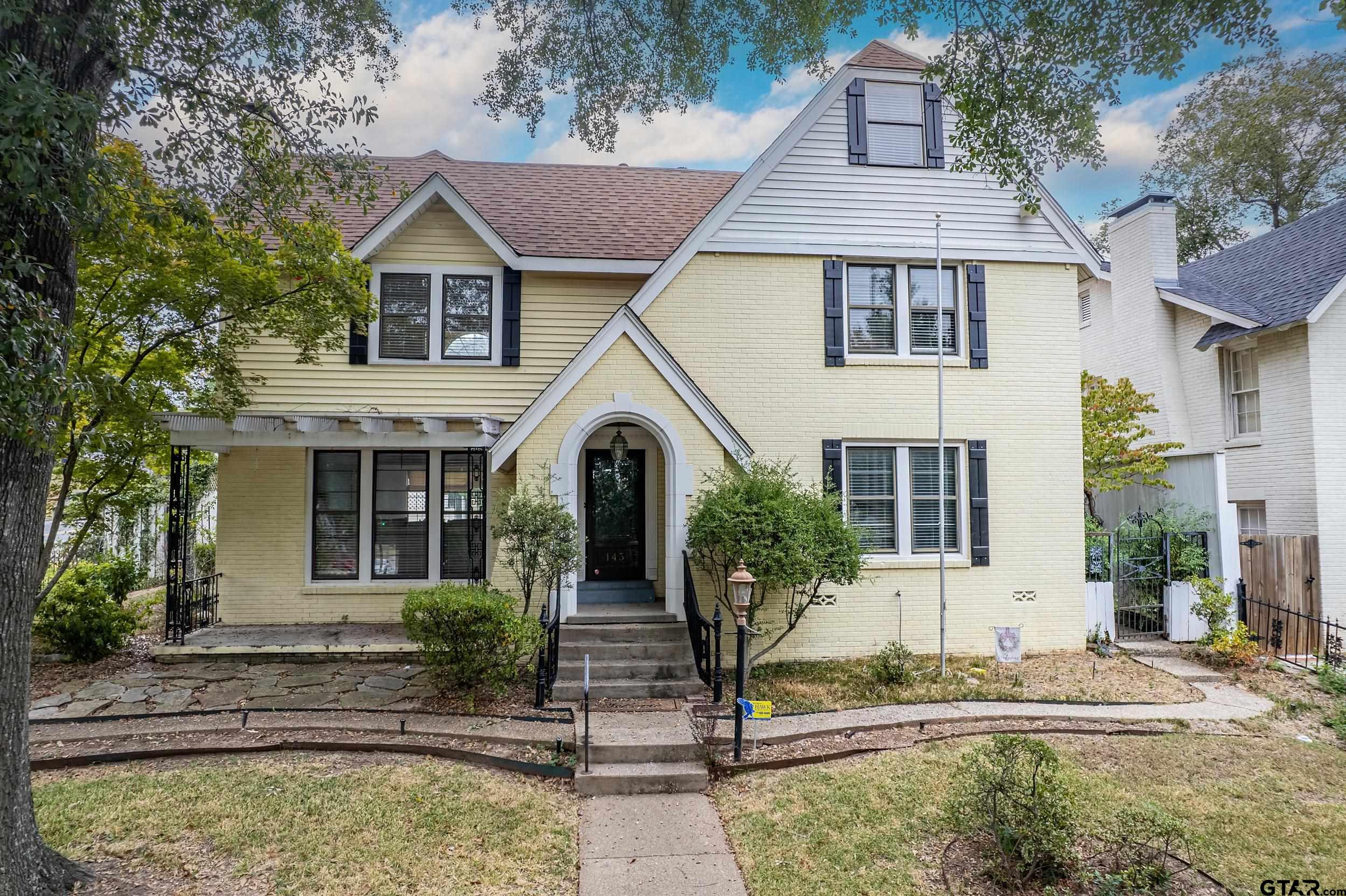 145 Rowland Place Tyler, TX 75701 - Photo 1 of 43 a front view of a house with a garden
