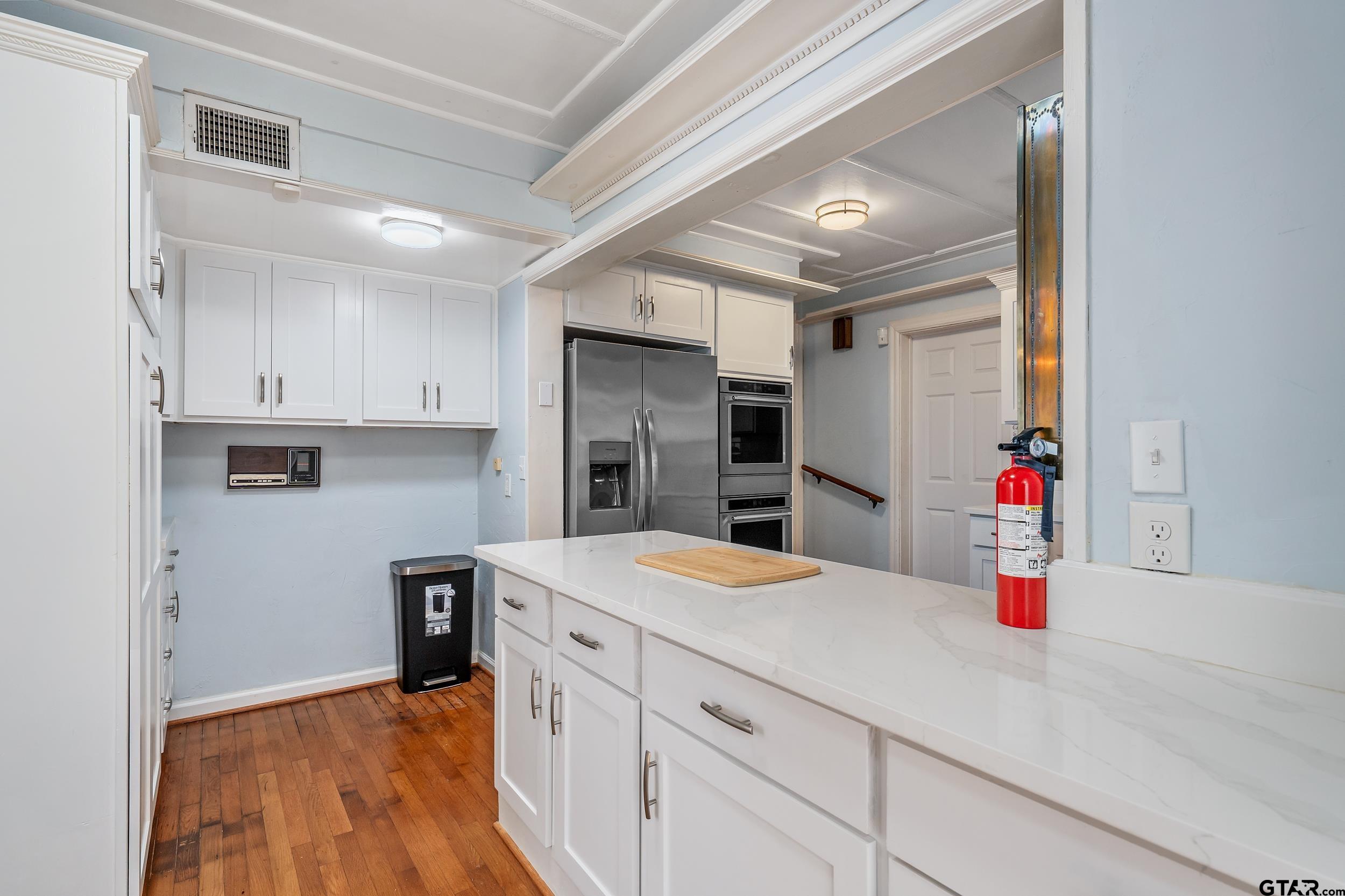 145 Rowland Place Tyler, TX 75701 - Photo 22 of 43 a kitchen with a refrigerator and sink