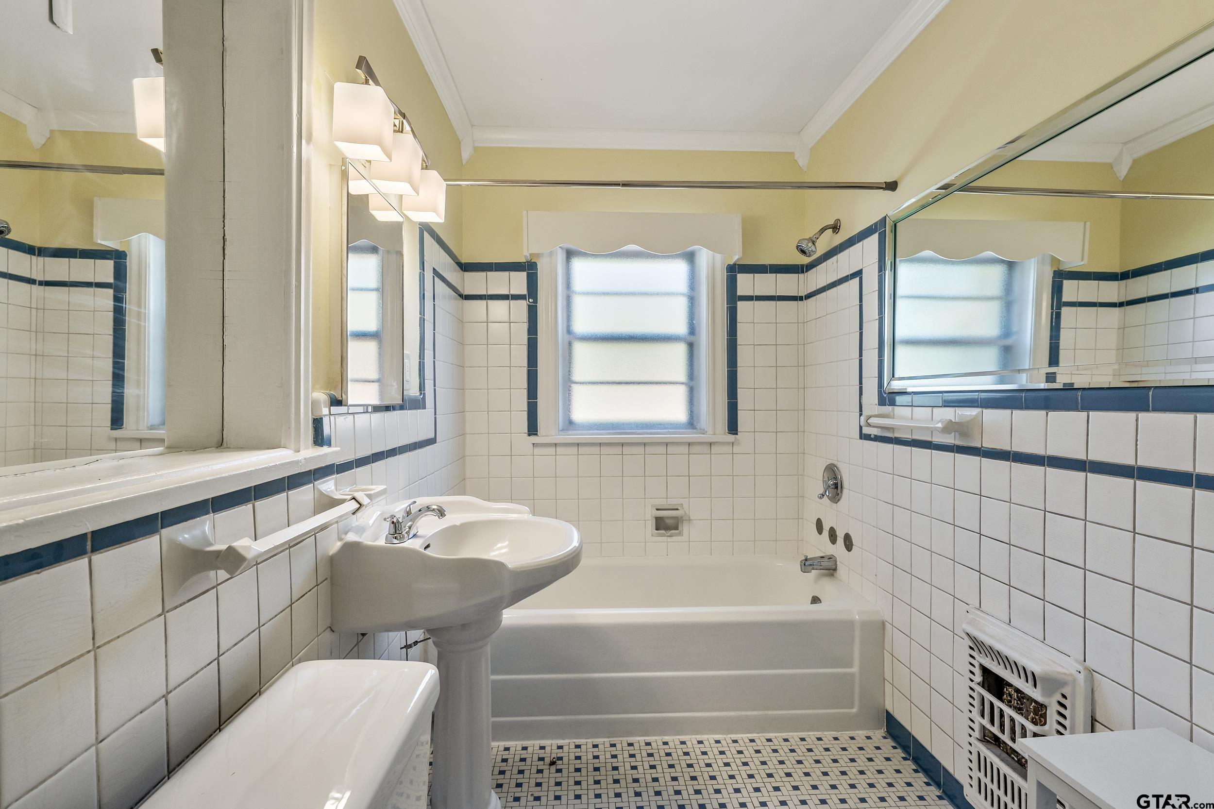 145 Rowland Place Tyler, TX 75701 - Photo 26 of 43 a bathroom with a sink a toilet a bathtub and shower