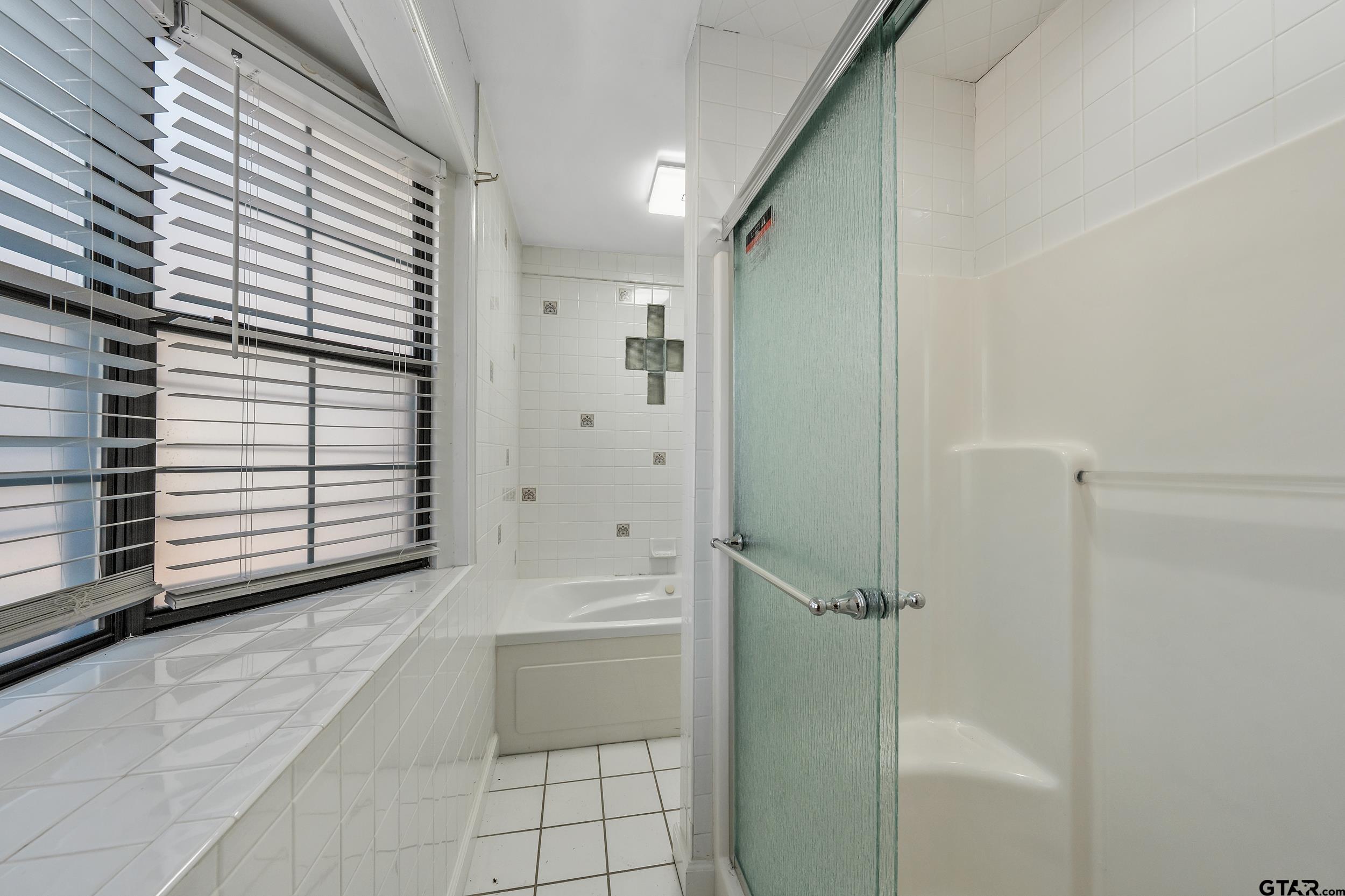 145 Rowland Place Tyler, TX 75701 - Photo 27 of 43 a bathroom with a bathtub and shower