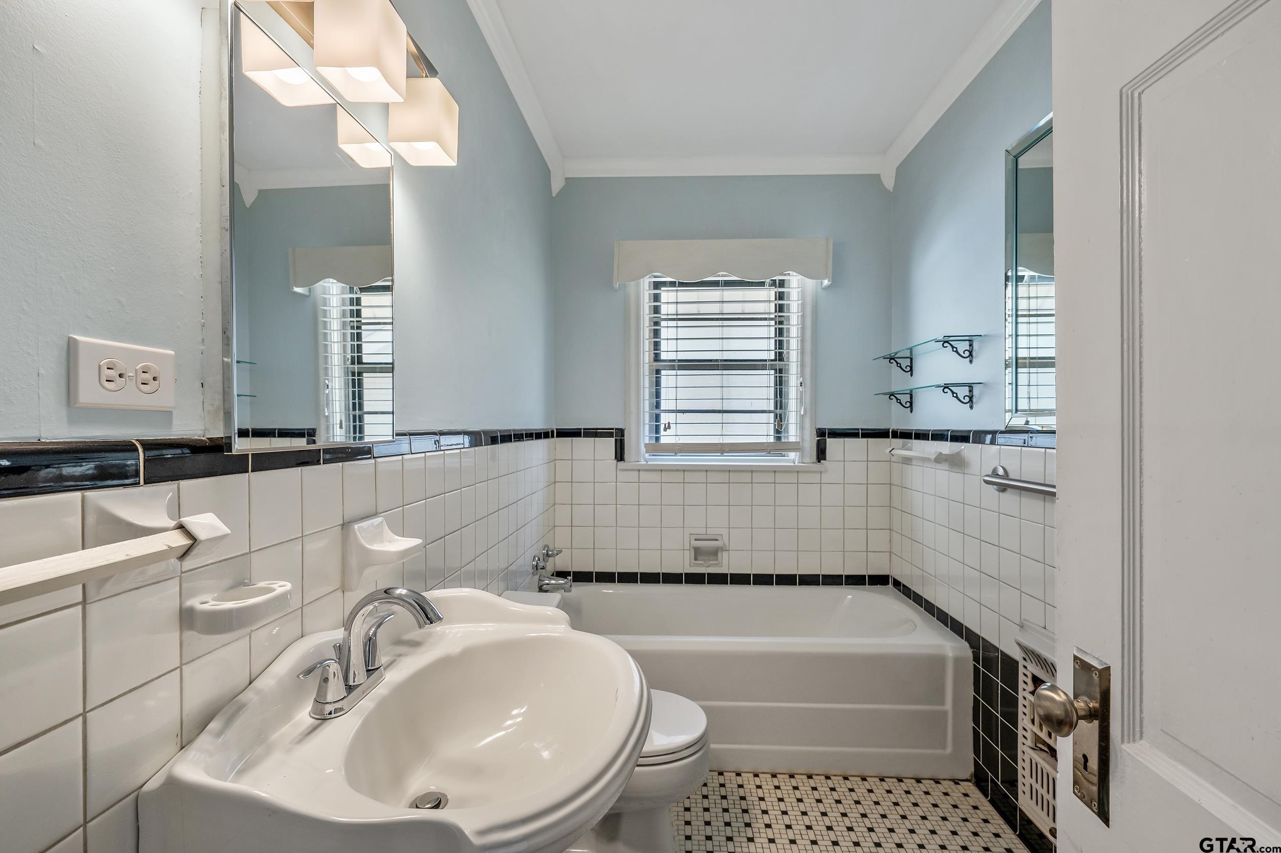 145 Rowland Place Tyler, TX 75701 - Photo 28 of 43 a bathroom with a sink a toilet and bathtub