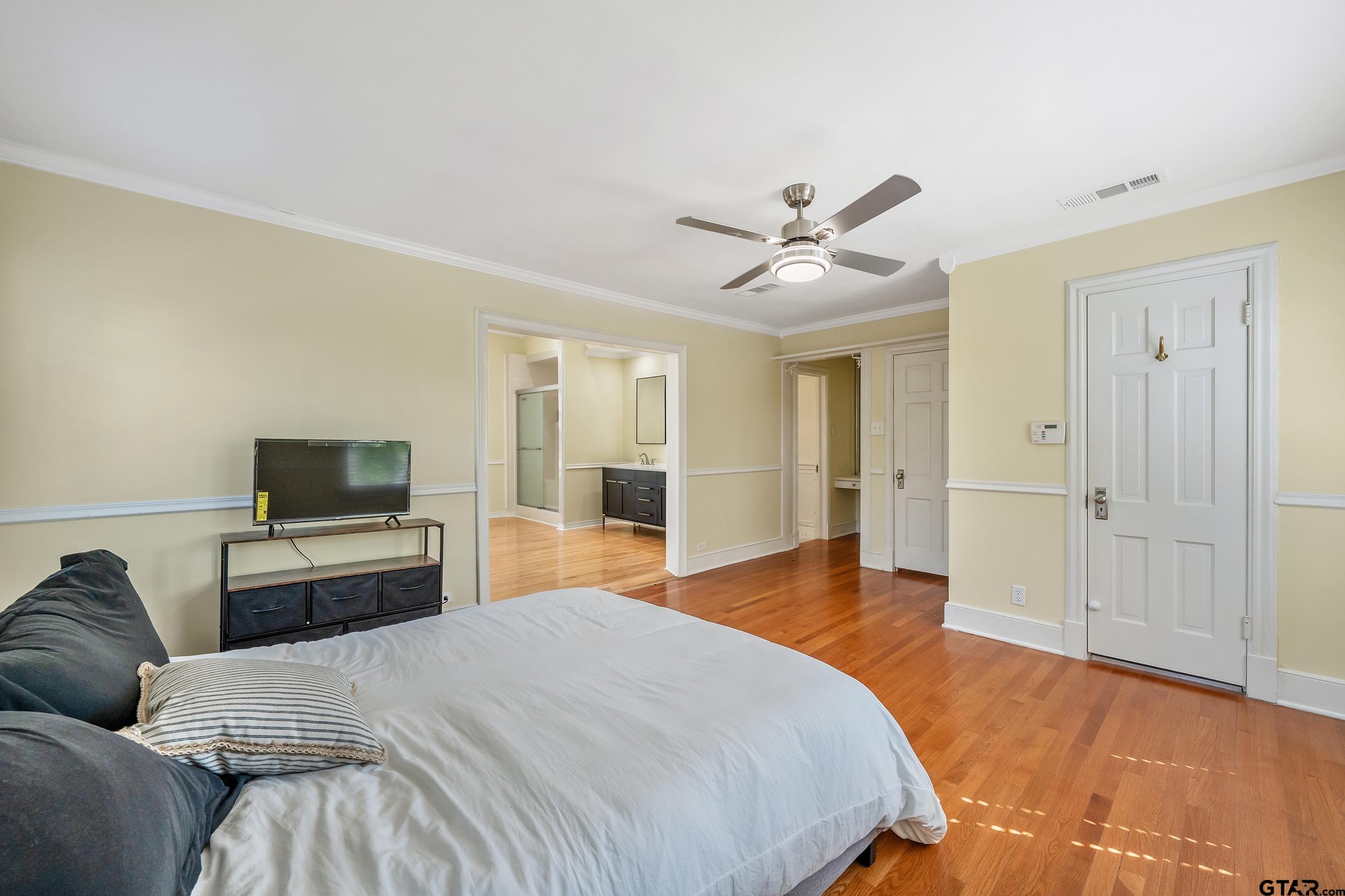 145 Rowland Place Tyler, TX 75701 - Photo 31 of 43 a spacious bedroom with a bed and a flat screen tv