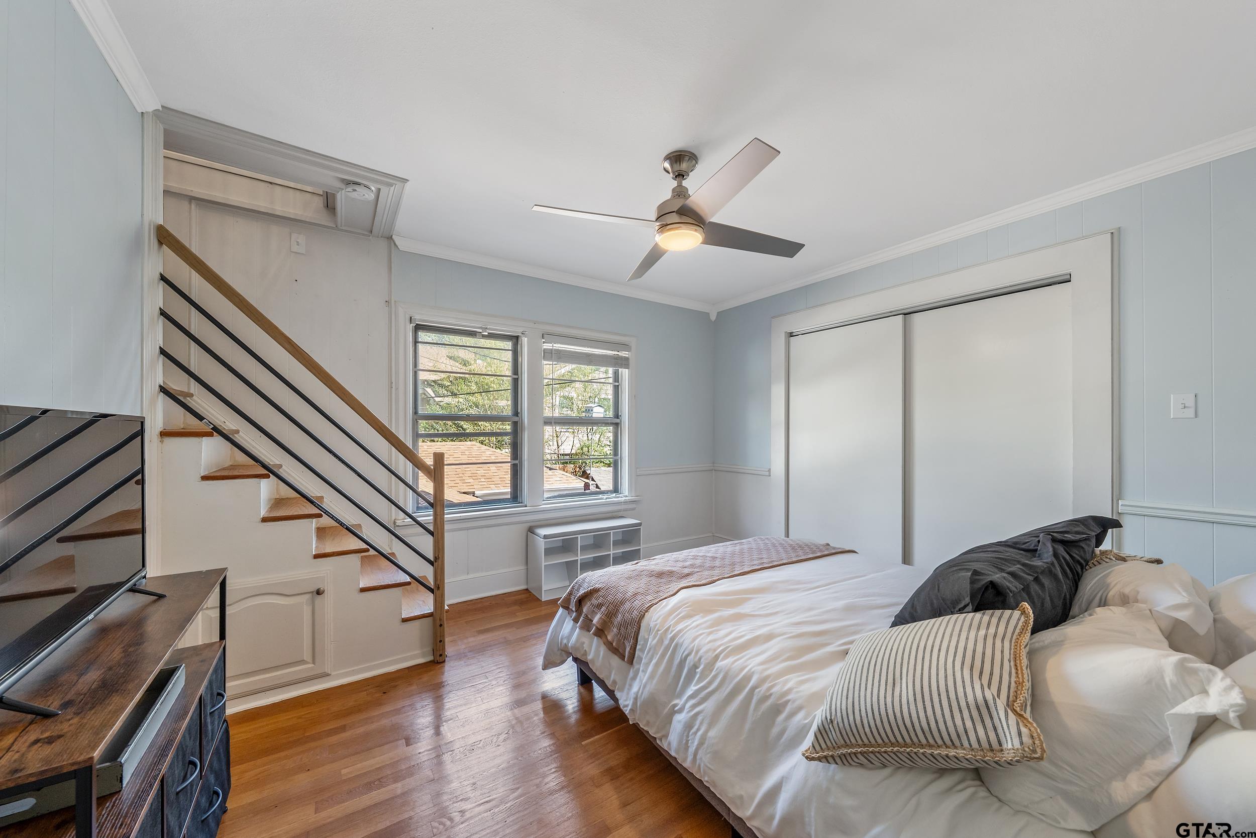 145 Rowland Place Tyler, TX 75701 - Photo 33 of 43 a bedroom with a large bed and a chandelier