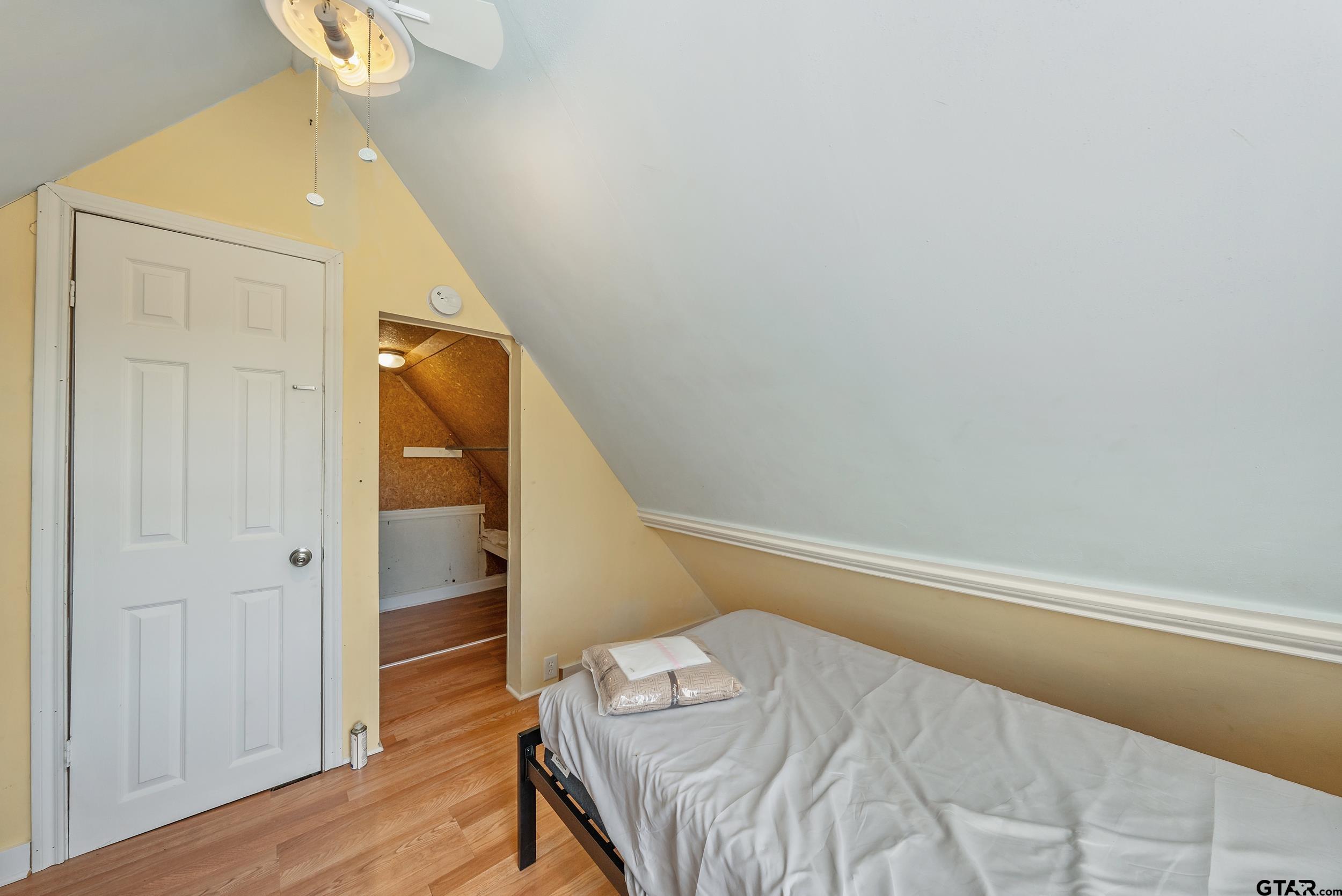 145 Rowland Place Tyler, TX 75701 - Photo 35 of 43 a bedroom with a bed and wooden floor