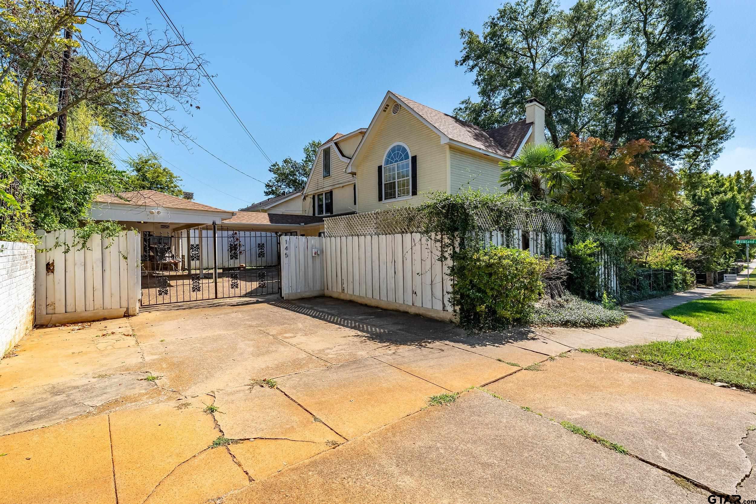 145 Rowland Place Tyler, TX 75701 - Photo 38 of 43 a front view of a house with a yard and garage