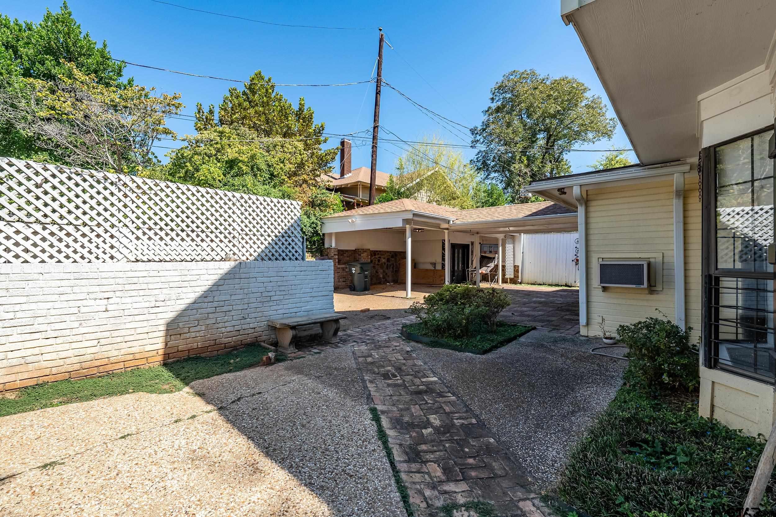 145 Rowland Place Tyler, TX 75701 - Photo 40 of 43 a front view of a house with a garden