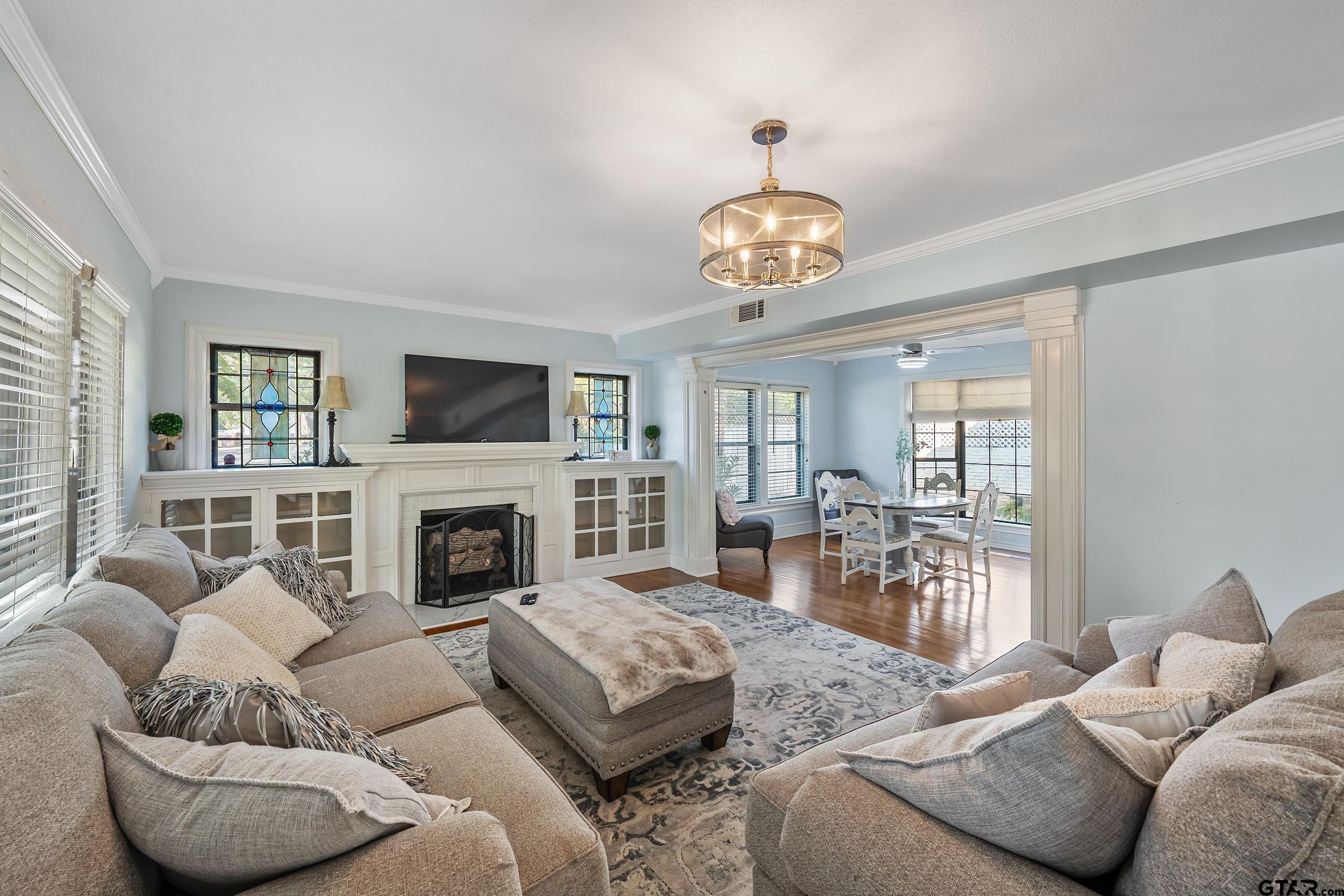 145 Rowland Place Tyler, TX 75701 - Photo 10 of 43 a living room with furniture a fireplace and a flat screen tv