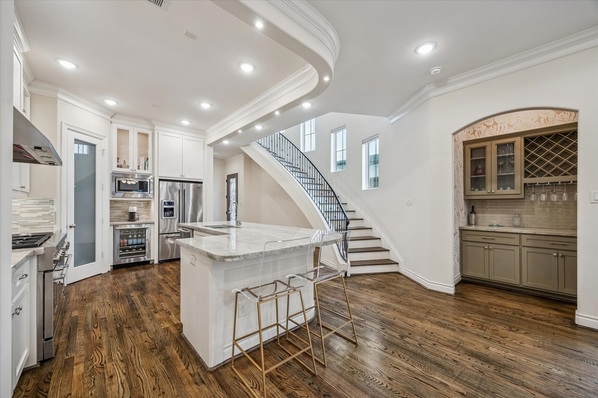 5305 Gibson Street Houston, TX 77007 - Photo 13 of 46 a kitchen with stainless steel appliances kitchen island wooden floors granite top and stove