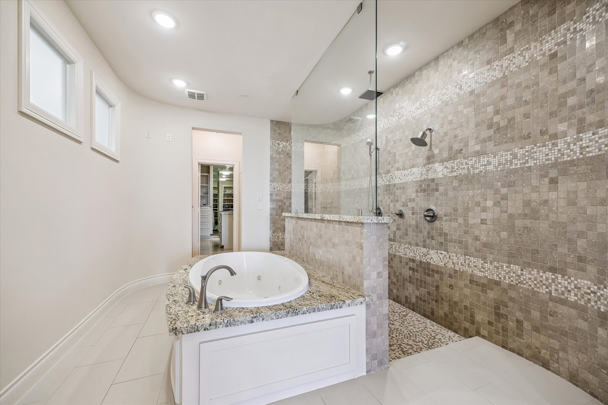 5305 Gibson Street Houston, TX 77007 - Photo 24 of 46 a bathroom with a granite countertop sink a bathtub and shower