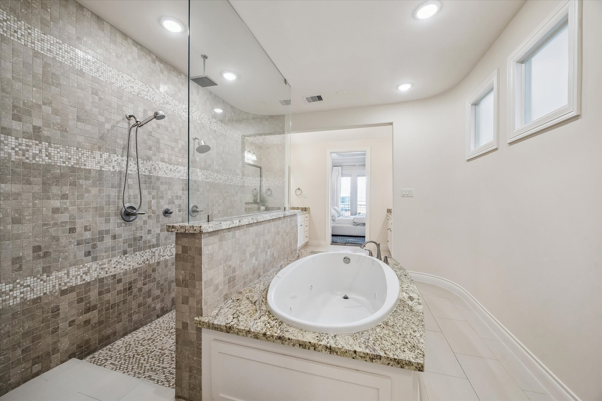 5305 Gibson Street Houston, TX 77007 - Photo 25 of 46 a bathroom with a granite countertop sink a mirror and shower