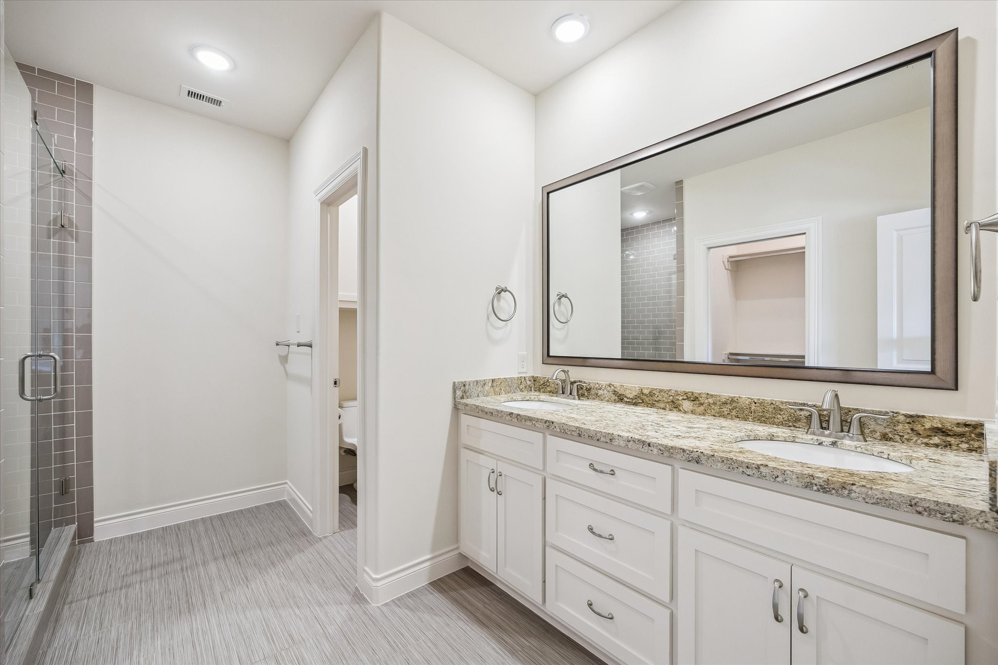5305 Gibson Street Houston, TX 77007 - Photo 32 of 46 a bathroom with a granite countertop sink double and mirror