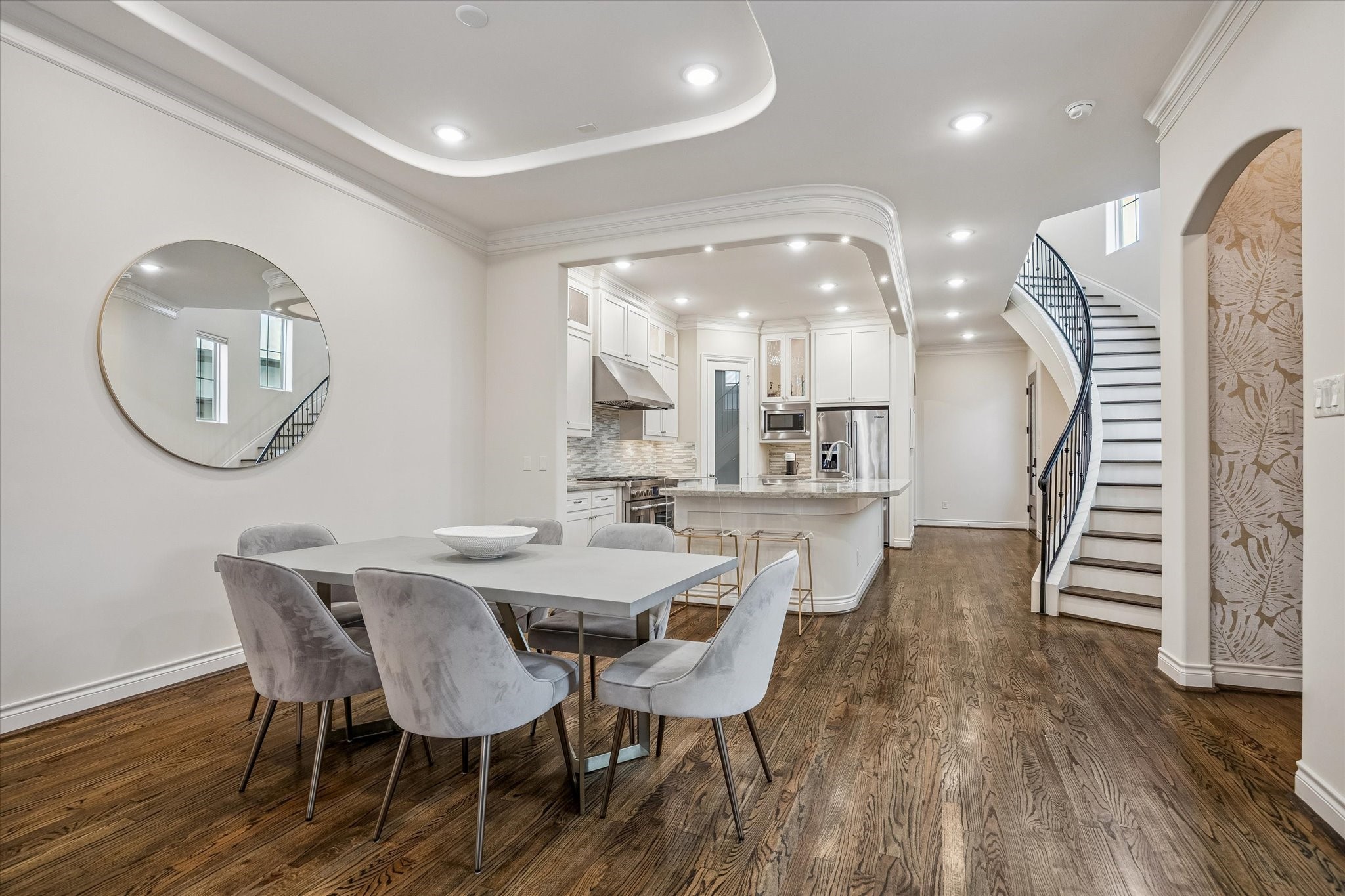 5305 Gibson Street Houston, TX 77007 - Photo 9 of 46 a dining room with wooden floor a glass table and chairs