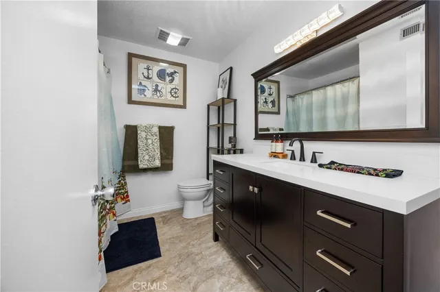 a bathroom with a sink vanity and a mirror