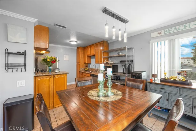 a view of a dining room with furniture and a chandelier