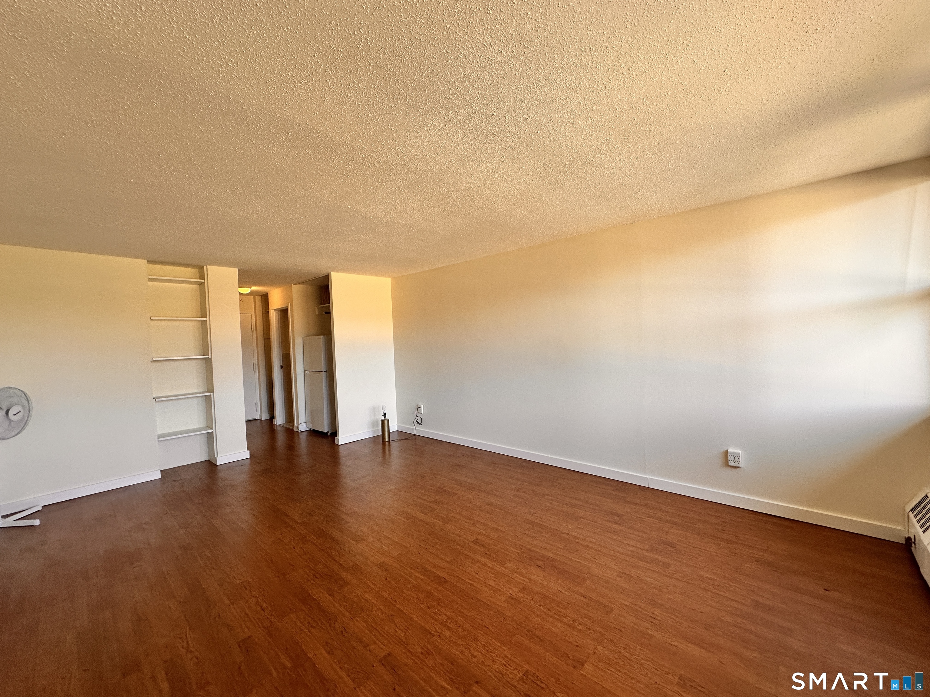 25 Ellsworth Street, Unit 17 Bridgeport, CT 06605 - Photo 12 of 30 a view of an empty room with wooden floor and a window