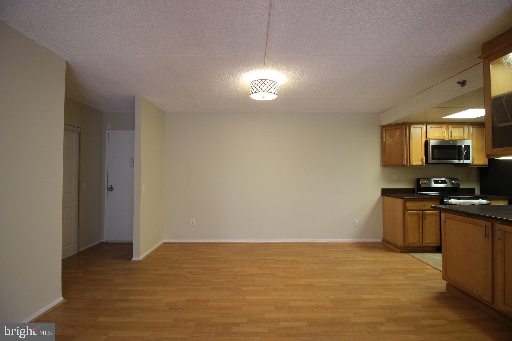 5911 Edsall Road, Unit 405 Alexandria, VA 22304 - Photo 2 of 23 a view of a kitchen with microwave and cabinets