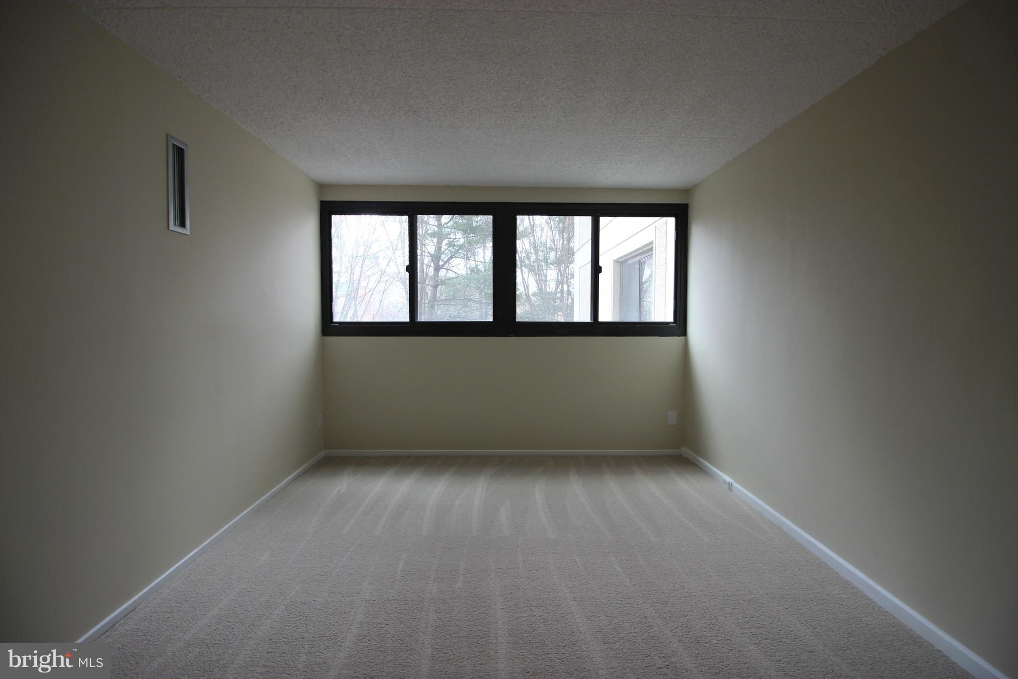 5911 Edsall Road, Unit 405 Alexandria, VA 22304 - Photo 12 of 23 an empty room with a empty space and windows