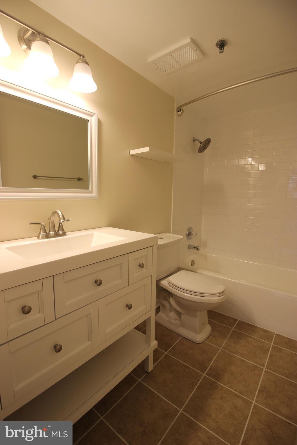 5911 Edsall Road, Unit 405 Alexandria, VA 22304 - Photo 15 of 23 a bathroom with a double vanity sink mirror and toilet