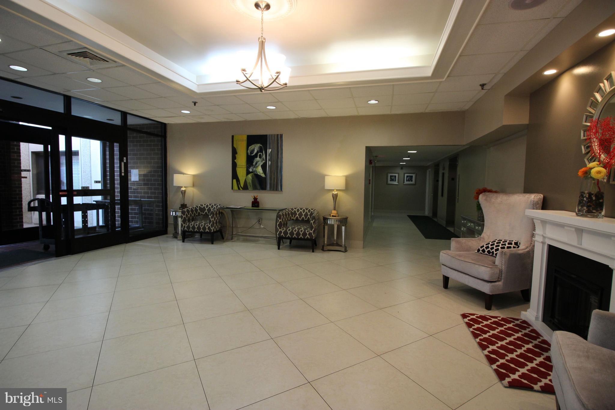 5911 Edsall Road, Unit 405 Alexandria, VA 22304 - Photo 19 of 23 a lobby with furniture and a chandelier