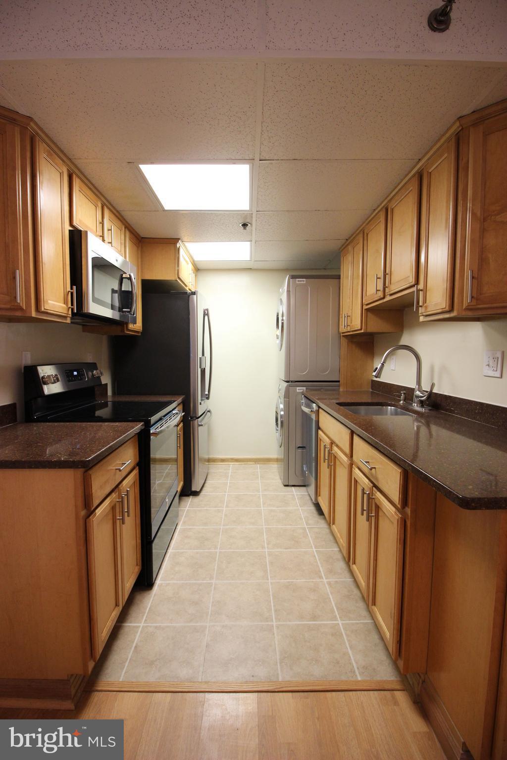 5911 Edsall Road, Unit 405 Alexandria, VA 22304 - Photo 6 of 23 a kitchen with stainless steel appliances granite countertop a stove a sink and a refrigerator