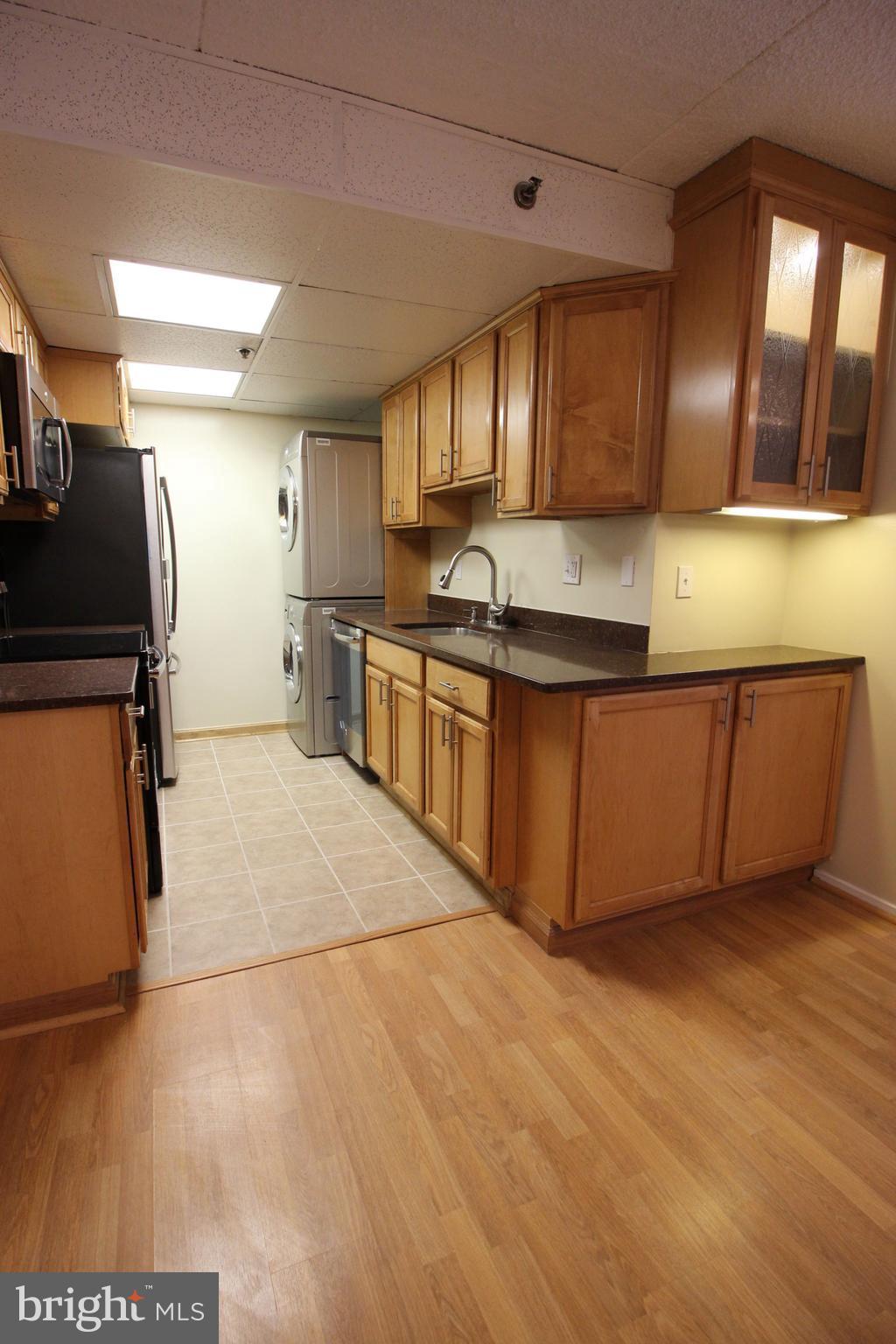 5911 Edsall Road, Unit 405 Alexandria, VA 22304 - Photo 7 of 23 a large kitchen with stainless steel appliances granite countertop a sink and cabinets