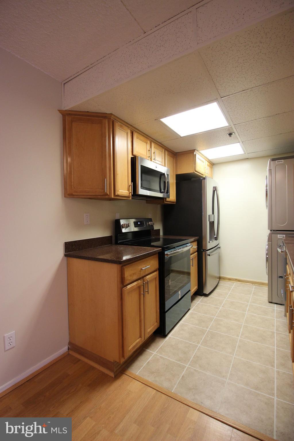 5911 Edsall Road, Unit 405 Alexandria, VA 22304 - Photo 8 of 23 a kitchen with stainless steel appliances granite countertop a stove a sink and a refrigerator
