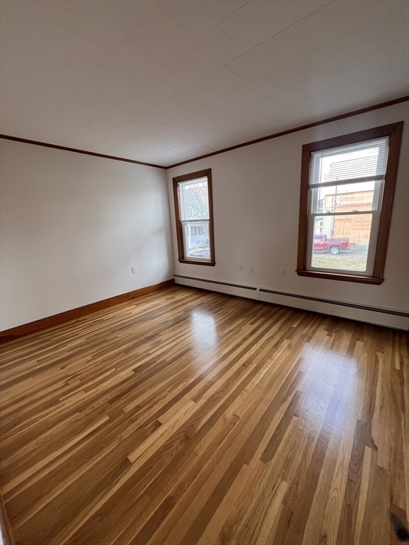 24 Proctor Street, Unit 2 Peabody, MA 01960 - Photo 11 of 19 an empty room with wooden floor and windows