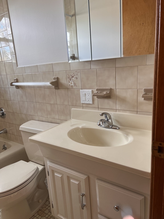 24 Proctor Street, Unit 2 Peabody, MA 01960 - Photo 14 of 19 a bathroom with a sink and a toilet