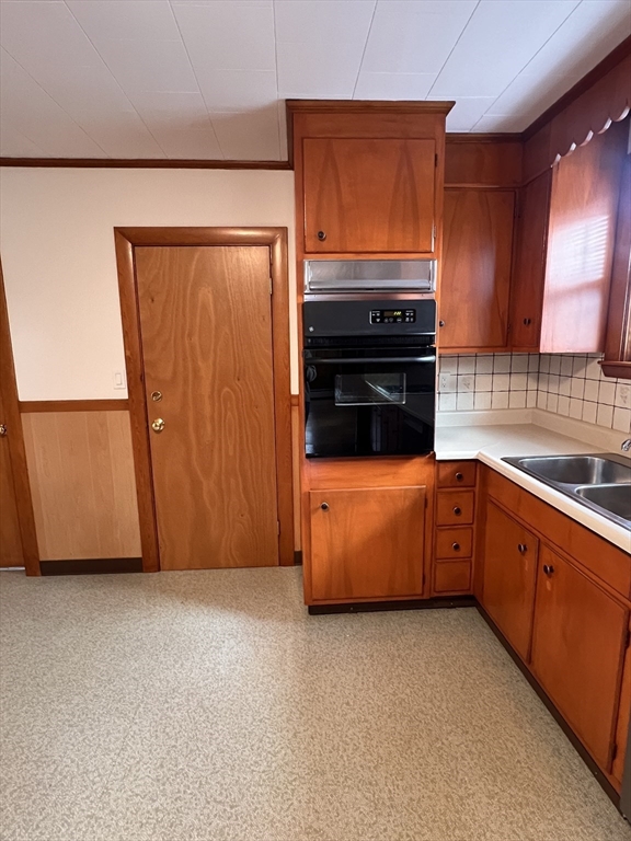 24 Proctor Street, Unit 2 Peabody, MA 01960 - Photo 2 of 19 a kitchen with wooden cabinets and a stove top oven