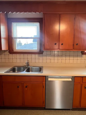 a kitchen with a sink cabinets and window