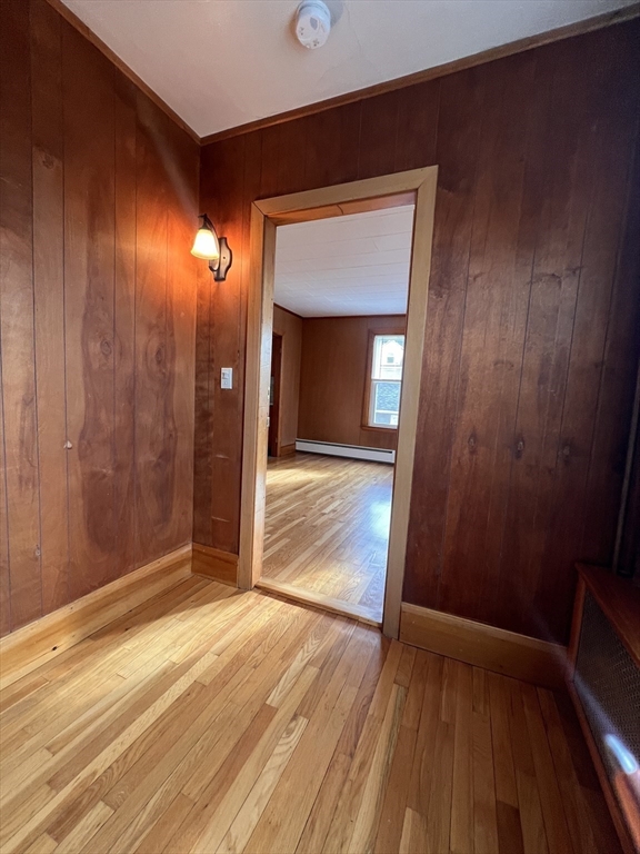 24 Proctor Street, Unit 2 Peabody, MA 01960 - Photo 8 of 19 an empty room with wooden floor and entrance