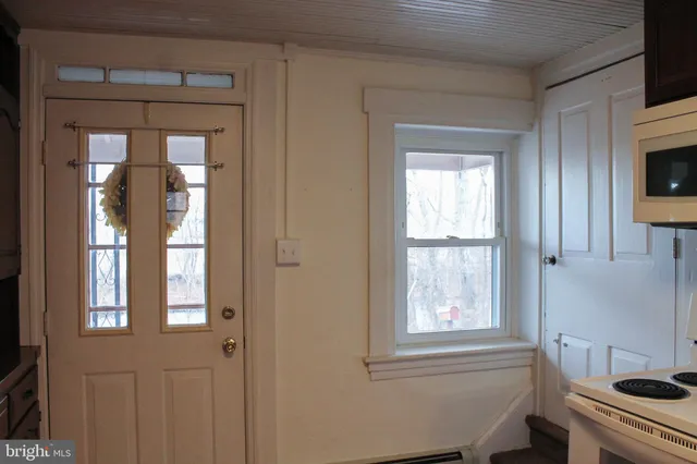 a bathroom with a window and a bathtub