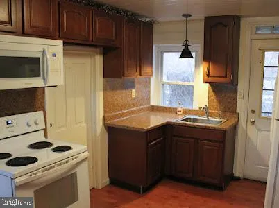 a kitchen with a stove and a refrigerator