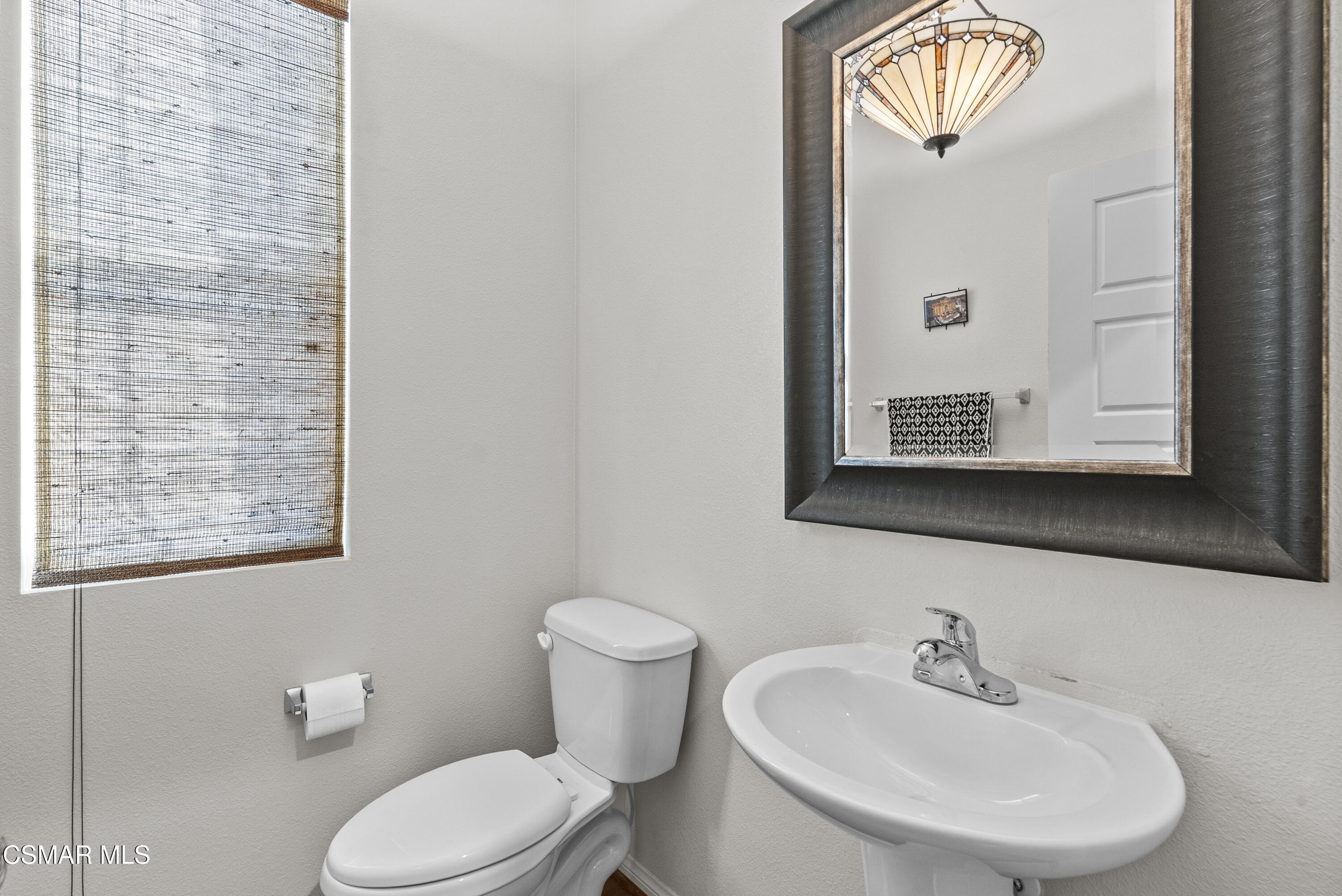 6441 Summit Village Lane, Unit 3 Simi Valley, CA 93063 - Photo 16 of 41 a bathroom with a toilet sink and mirror