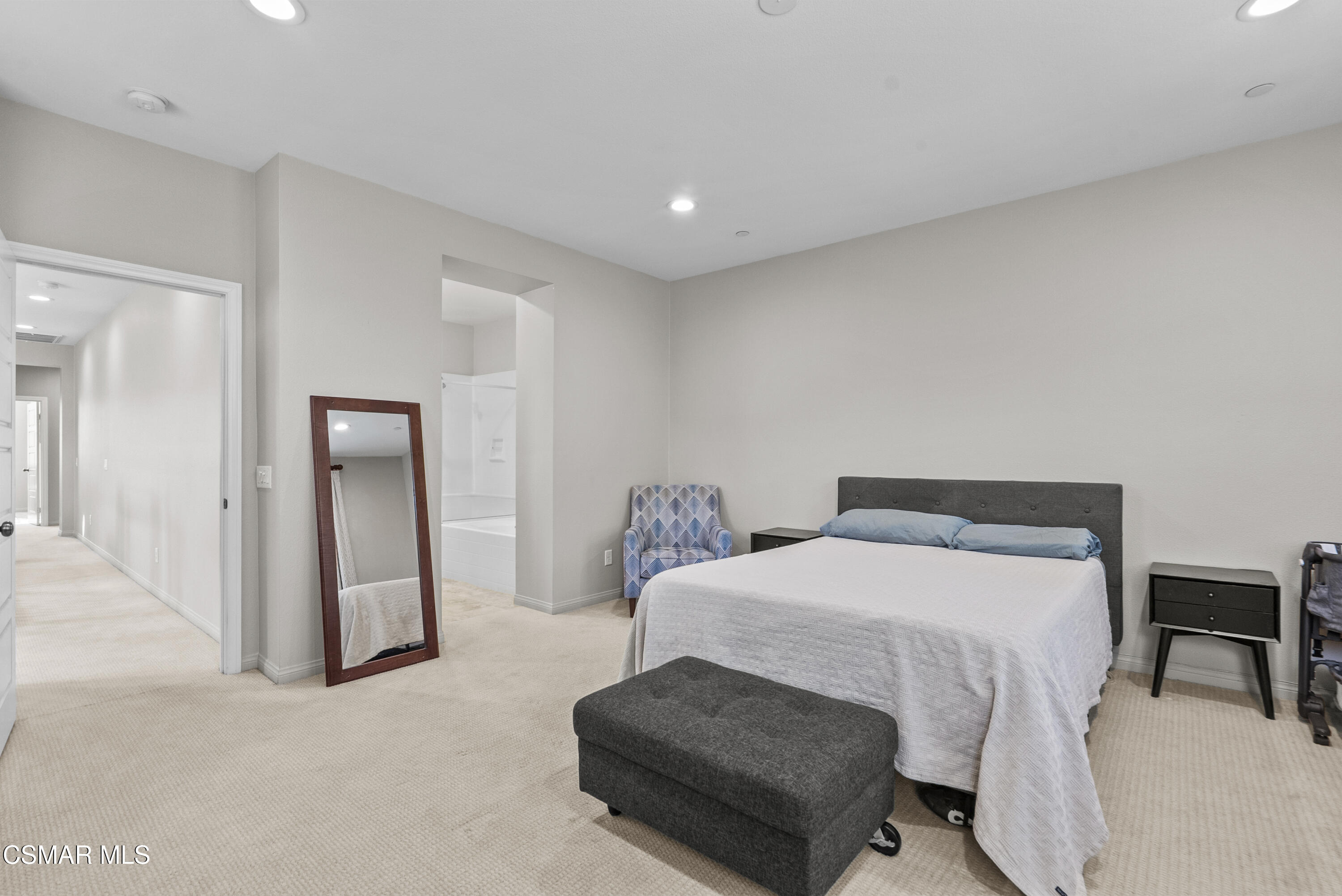 6441 Summit Village Lane, Unit 3 Simi Valley, CA 93063 - Photo 19 of 41 a spacious bedroom with a bed and a chair