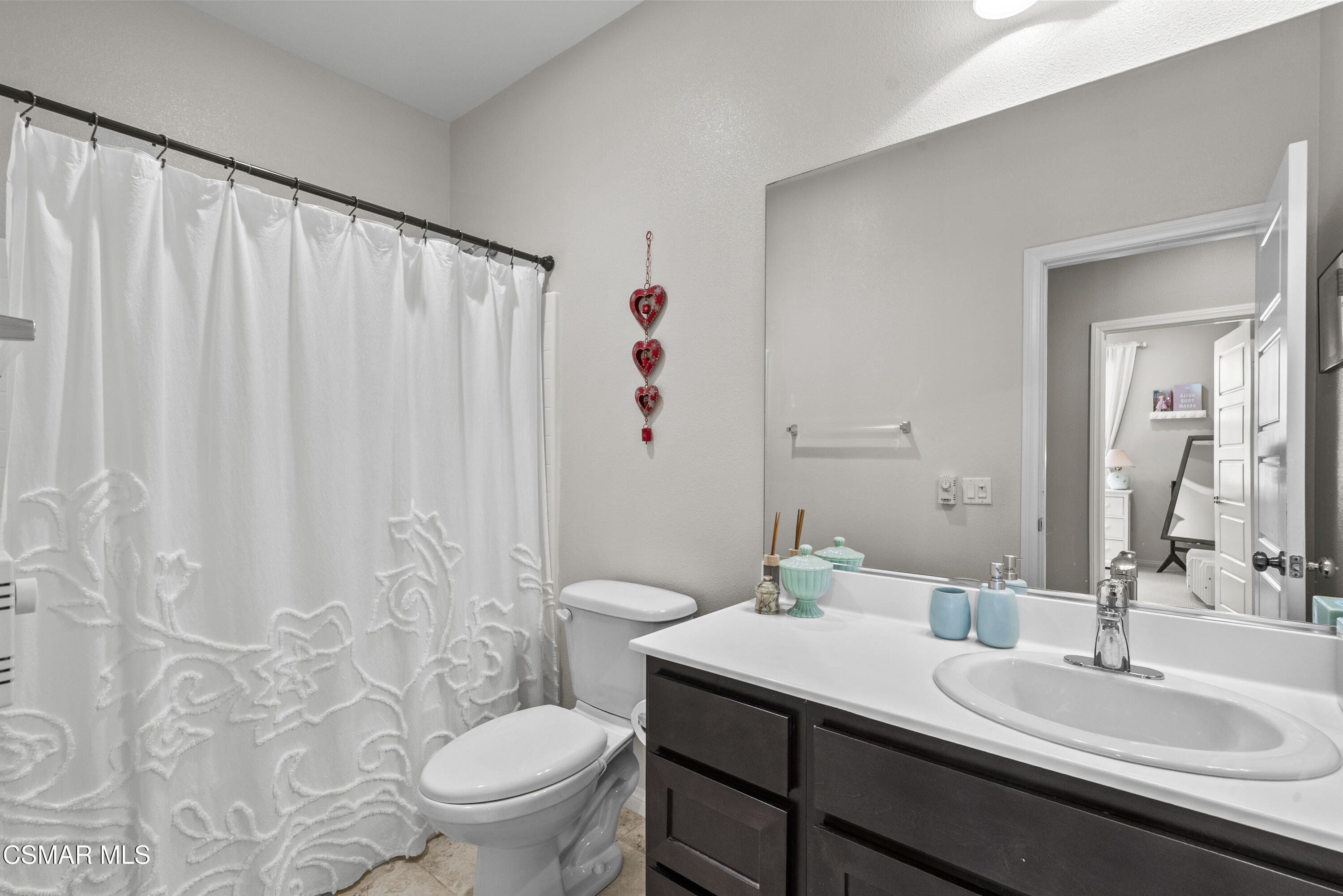 6441 Summit Village Lane, Unit 3 Simi Valley, CA 93063 - Photo 28 of 41 a bathroom with a granite countertop sink a toilet and a mirror
