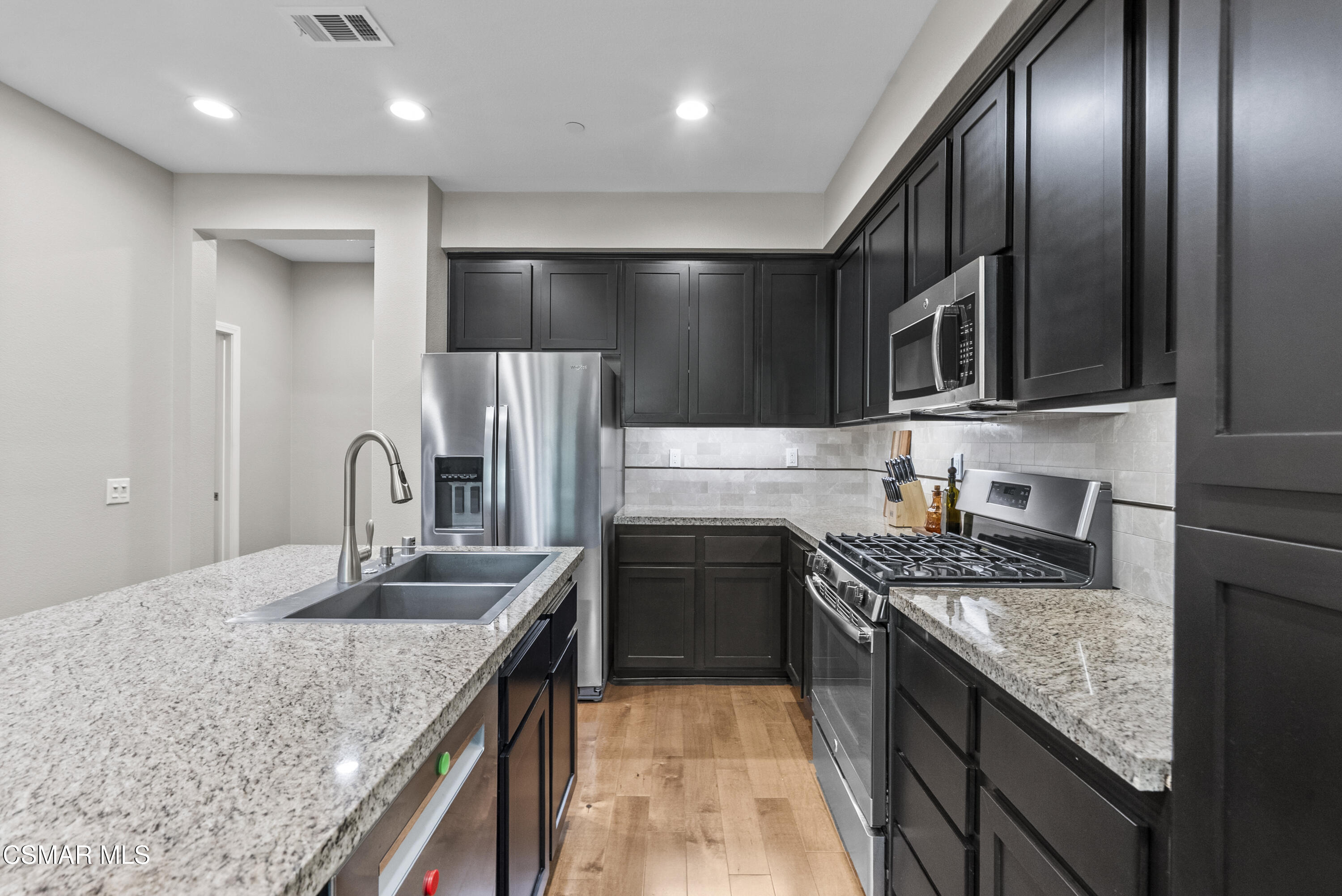 6441 Summit Village Lane, Unit 3 Simi Valley, CA 93063 - Photo 9 of 41 a kitchen with stainless steel appliances granite countertop a sink stove and refrigerator