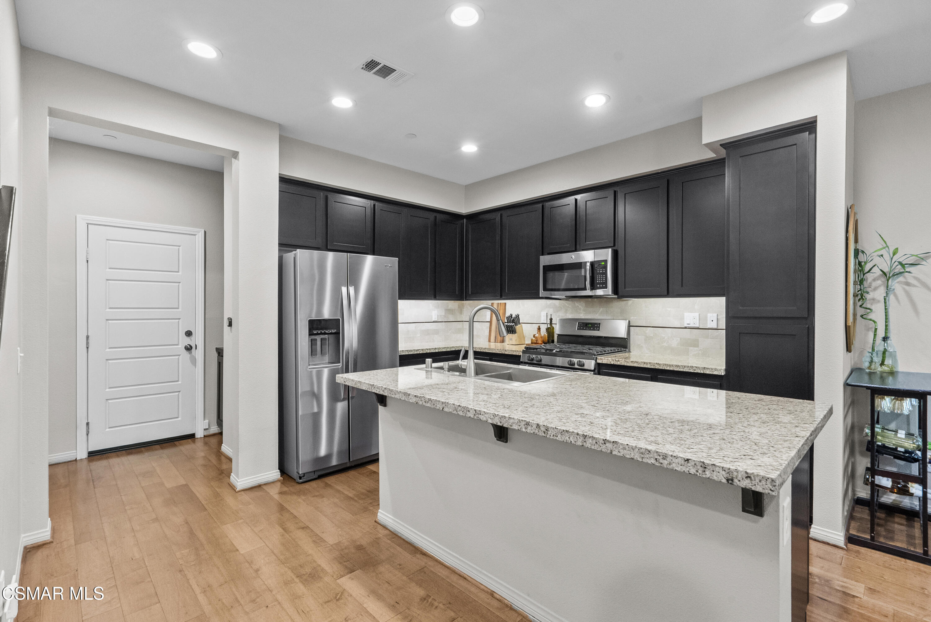 6441 Summit Village Lane, Unit 3 Simi Valley, CA 93063 - Photo 10 of 41 a kitchen with stainless steel appliances granite countertop a refrigerator stove a sink and dishwasher
