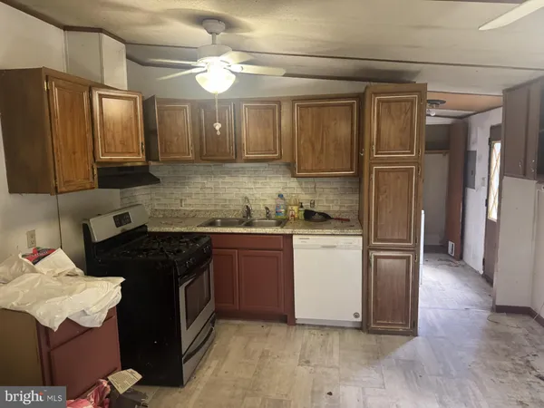 a kitchen with a refrigerator sink and cabinets