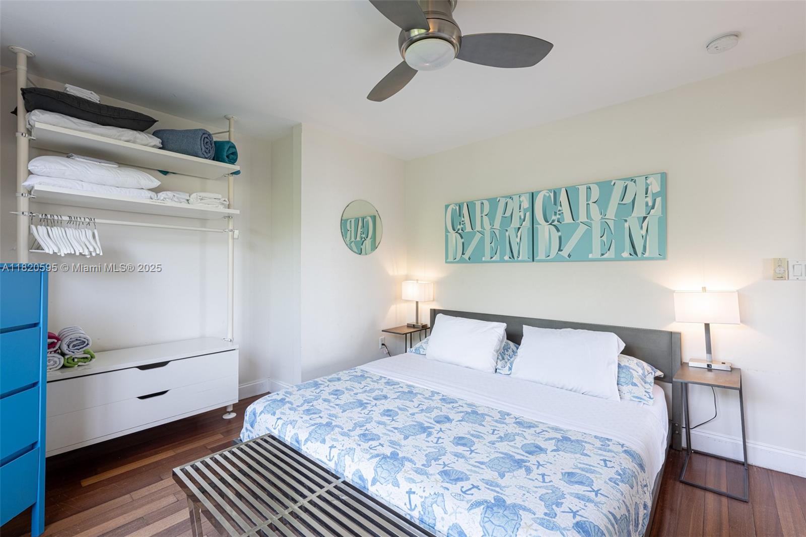 420 15th Street, Unit 307 Miami Beach, FL 33139 - Photo 13 of 22 a bedroom with a bed and wooden floor