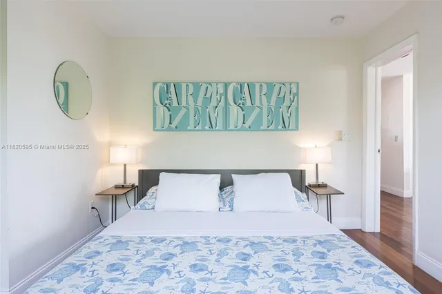 a bedroom with a bed and a lamp on dresser